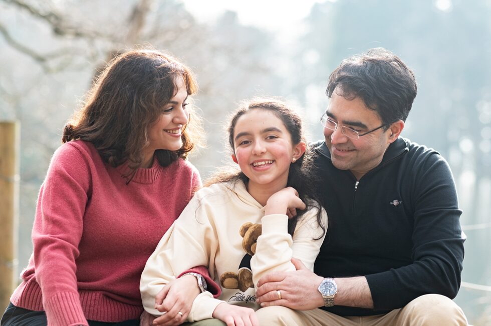 family photo session in bingley, West Yorkshire, with a mum and dad smiling at their teenage daughter