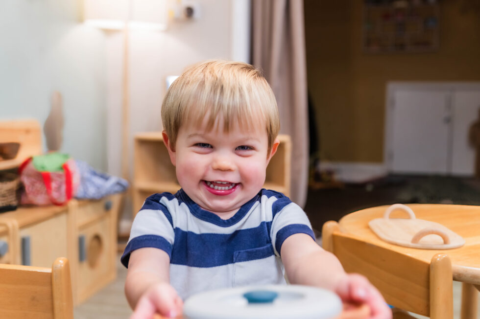 Nursery pupil having fun in the cooking area of his day nursery in Keighley, West Yorkshire