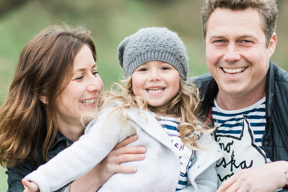 Family relaxing together during an outdoor portrait session in the countryside near Leeds, Yorkshire