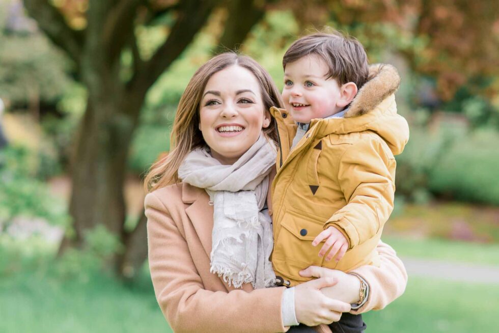 Mother holding her young son in a park during an autumn family photography session in Harrogate, Yorkshire