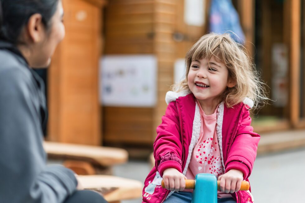 Smiling child playing in a classroom during a nursery photography session for educational marketing in Halifax, West Yorkshire