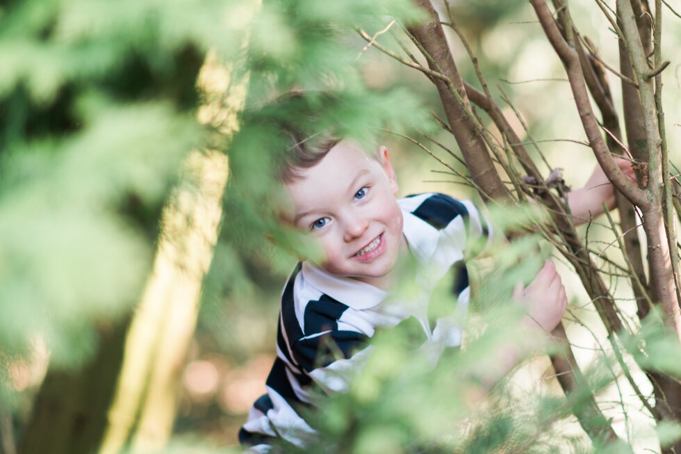 Young boy playing in the woods during a family photo shoot in Bradford, West Yorkshire
