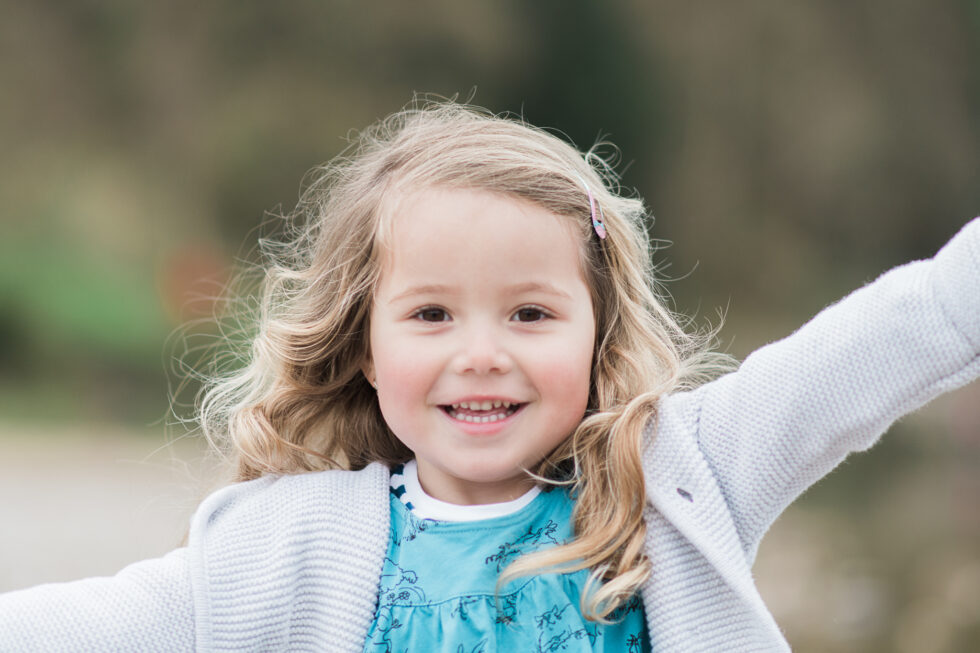 Smiling little girl during an outdoor family photography session in Leeds, West Yorkshire