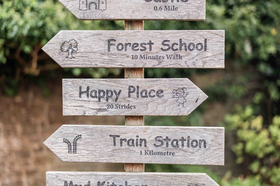 Forest school signpost photographed during an outdoor nursery photography session in Ilkley, West Yorkshire